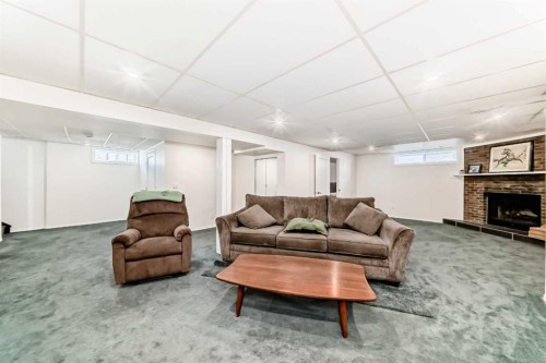 148 Huntridge Road Ne, Calgary, AB - Indoor With Fireplace