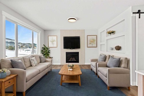 157 Vantage Drive, Cochrane, AB - Indoor Photo Showing Living Room With Fireplace