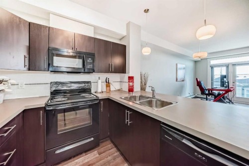 405-2300 Evanston Square, Calgary, AB - Indoor Photo Showing Kitchen With Double Sink