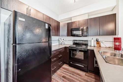405-2300 Evanston Square, Calgary, AB - Indoor Photo Showing Kitchen With Double Sink