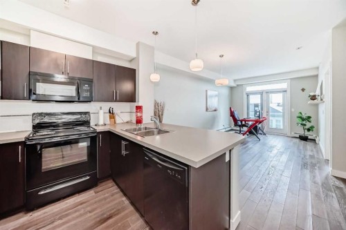 405-2300 Evanston Square, Calgary, AB - Indoor Photo Showing Kitchen With Double Sink