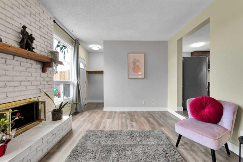44 Strathclair Rise Sw, Calgary, AB - Indoor Photo Showing Living Room With Fireplace