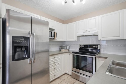 94 Mt Aberdeen Manor Se, Calgary, AB - Indoor Photo Showing Kitchen With Stainless Steel Kitchen With Double Sink