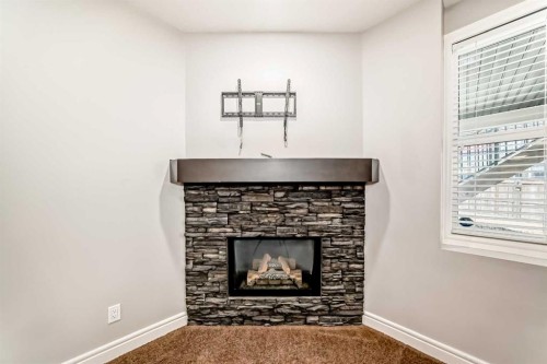 7904 Masters Boulevard Se, Calgary, AB - Indoor Photo Showing Living Room With Fireplace