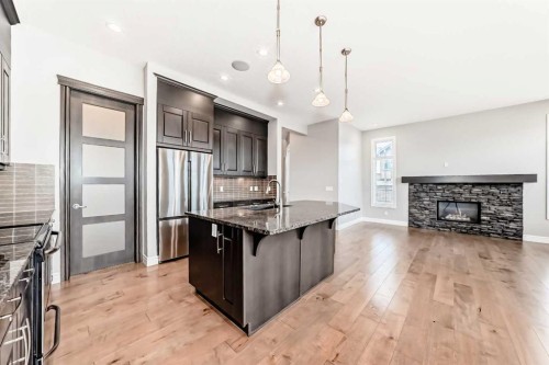 7904 Masters Boulevard Se, Calgary, AB - Indoor Photo Showing Kitchen With Fireplace With Upgraded Kitchen