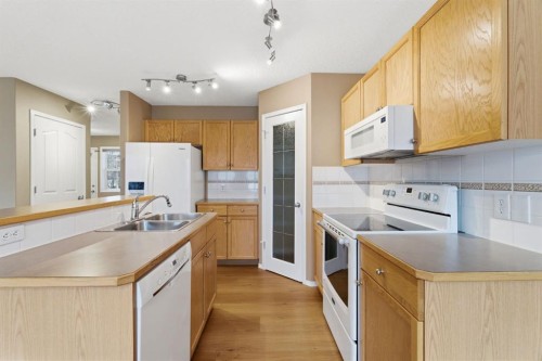 59 Silver Springs Way Nw, Airdrie, AB - Indoor Photo Showing Kitchen With Double Sink