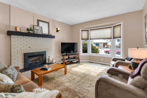4640 Rundlehill Road Ne, Calgary, AB - Indoor Photo Showing Living Room With Fireplace