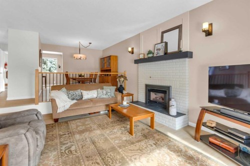 4640 Rundlehill Road Ne, Calgary, AB - Indoor Photo Showing Living Room With Fireplace