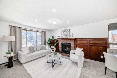6735 Temple Drive Ne, Calgary, AB - Indoor Photo Showing Living Room With Fireplace