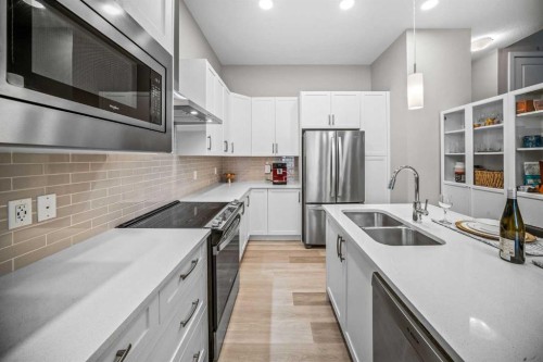 210 Crestbrook Common Sw, Calgary, AB - Indoor Photo Showing Kitchen With Double Sink With Upgraded Kitchen