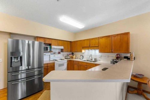 215-200 Lincoln Way Sw, Calgary, AB - Indoor Photo Showing Kitchen With Double Sink