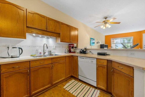 215-200 Lincoln Way Sw, Calgary, AB - Indoor Photo Showing Kitchen With Double Sink