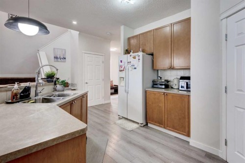 52 Bridlemeadows Common Sw, Calgary, AB - Indoor Photo Showing Kitchen With Double Sink