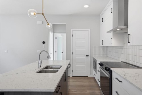 151 Ellen Road, Crossfield, AB - Indoor Photo Showing Kitchen With Double Sink With Upgraded Kitchen