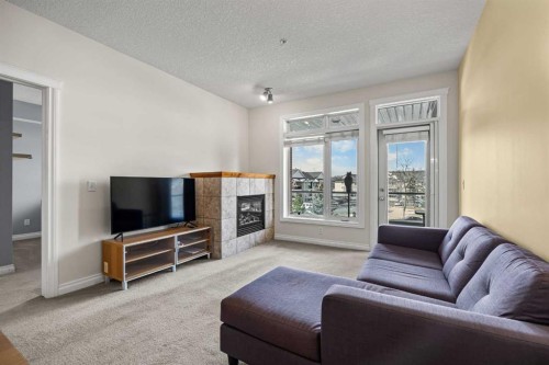 6309-14 Hemlock Crescent Sw, Calgary, AB - Indoor Photo Showing Living Room With Fireplace