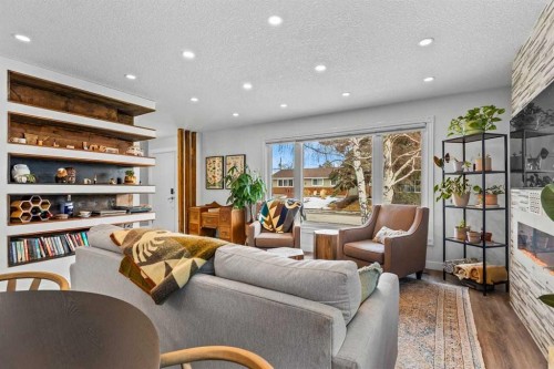 9963 Wilde Road Se, Calgary, AB - Indoor Photo Showing Other Room With Fireplace