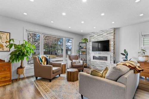 9963 Wilde Road Se, Calgary, AB - Indoor Photo Showing Living Room With Fireplace