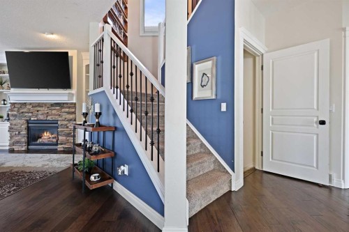 739 Cimarron Close, Okotoks, AB - Indoor Photo Showing Other Room With Fireplace