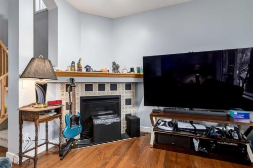 216 Silverado Range Close Sw, Calgary, AB - Indoor Photo Showing Other Room With Fireplace