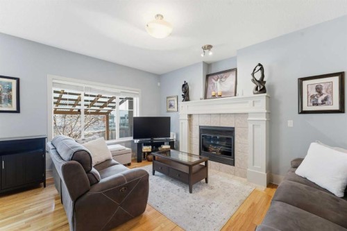 129 Cougartown Circle Sw, Calgary, AB - Indoor Photo Showing Living Room With Fireplace