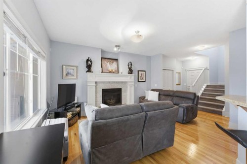 129 Cougartown Circle Sw, Calgary, AB - Indoor Photo Showing Living Room With Fireplace