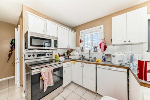 659 Maryvale Way Ne, Calgary, AB - Indoor Photo Showing Kitchen With Double Sink