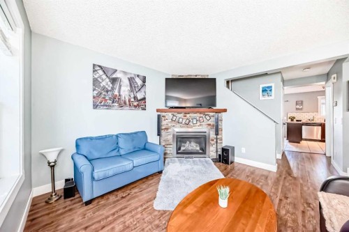 57 Martinvalley Way Ne, Calgary, AB - Indoor Photo Showing Living Room With Fireplace