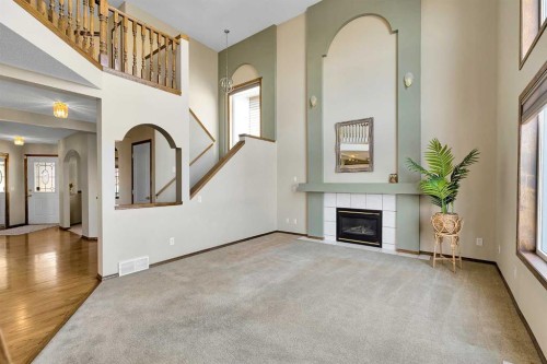271 Edgebrook Park Nw, Calgary, AB - Indoor Photo Showing Other Room With Fireplace