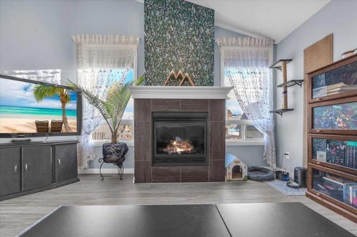 301 Mcleod Crescent, Diamond Valley, AB - Indoor Photo Showing Living Room With Fireplace