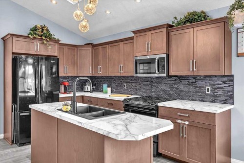 301 Mcleod Crescent, Diamond Valley, AB - Indoor Photo Showing Kitchen With Double Sink