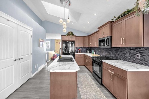 301 Mcleod Crescent, Diamond Valley, AB - Indoor Photo Showing Kitchen With Double Sink