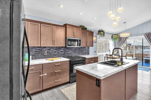 301 Mcleod Crescent, Diamond Valley, AB - Indoor Photo Showing Kitchen With Double Sink With Upgraded Kitchen