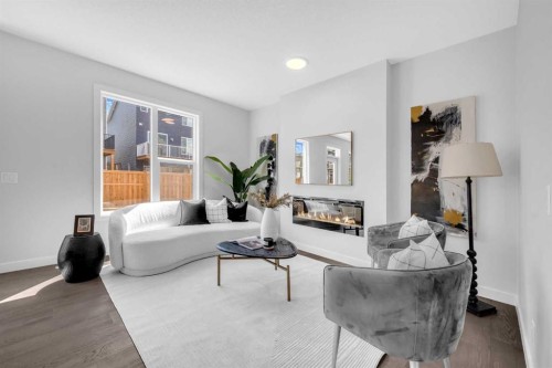 55 Amblehurst Link Nw, Calgary, AB - Indoor Photo Showing Living Room With Fireplace