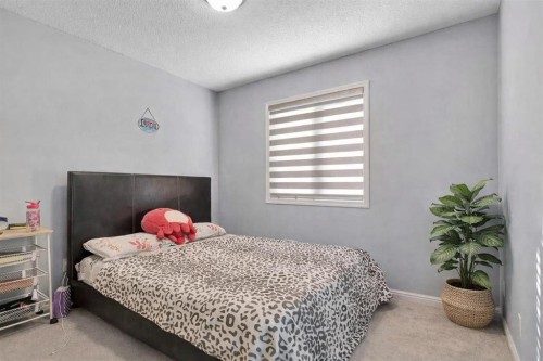 83 Luxstone Crescent Sw, Airdrie, AB - Indoor Photo Showing Bedroom