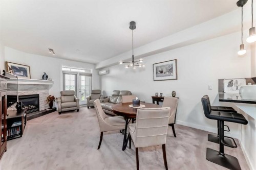211-1005A Westmount Drive, Strathmore, AB - Indoor Photo Showing Dining Room With Fireplace