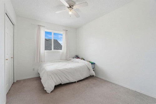 412 Sheep River Point, Okotoks, AB - Indoor Photo Showing Bedroom