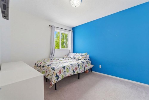 412 Sheep River Point, Okotoks, AB - Indoor Photo Showing Bedroom