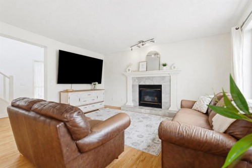 412 Sheep River Point, Okotoks, AB - Indoor Photo Showing Living Room With Fireplace