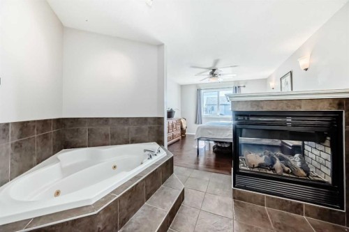 377 Cimarron Boulevard, Okotoks, AB - Indoor Photo Showing Bathroom With Fireplace