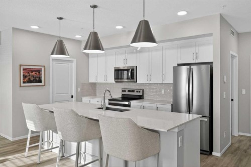 214-140 Mahogany Street Se, Calgary, AB - Indoor Photo Showing Kitchen With Stainless Steel Kitchen With Double Sink With Upgraded Kitchen