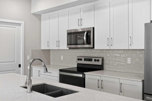 214-140 Mahogany Street Se, Calgary, AB - Indoor Photo Showing Kitchen With Stainless Steel Kitchen With Double Sink With Upgraded Kitchen