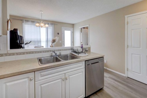 22 Tarington Landing Ne, Calgary, AB - Indoor Photo Showing Kitchen With Double Sink