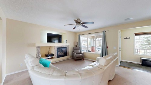 95 Covepark Place Ne, Calgary, AB - Indoor Photo Showing Living Room With Fireplace