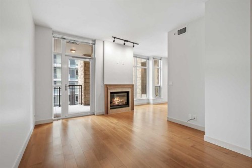 317-222 Riverfront Avenue Sw, Calgary, AB - Indoor Photo Showing Living Room With Fireplace