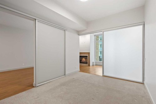 317-222 Riverfront Avenue Sw, Calgary, AB - Indoor Photo Showing Other Room With Fireplace
