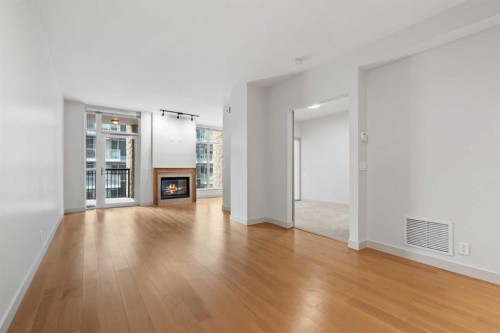 317-222 Riverfront Avenue Sw, Calgary, AB - Indoor Photo Showing Living Room With Fireplace