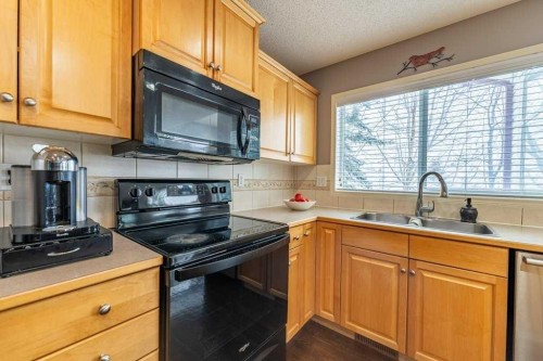 62 Springbluff Boulevard Sw, Calgary, AB - Indoor Photo Showing Kitchen With Double Sink
