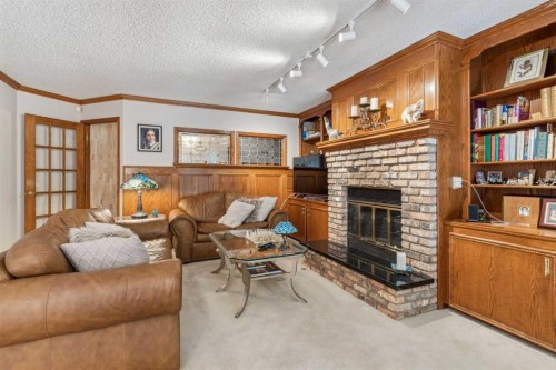 9948 Patton Road Sw, Calgary, AB - Indoor Photo Showing Living Room With Fireplace