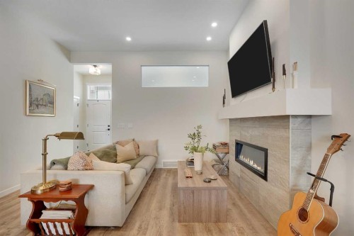 175 Magnolia Way Se, Calgary, AB - Indoor Photo Showing Living Room With Fireplace