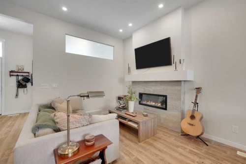 175 Magnolia Way Se, Calgary, AB - Indoor Photo Showing Living Room With Fireplace